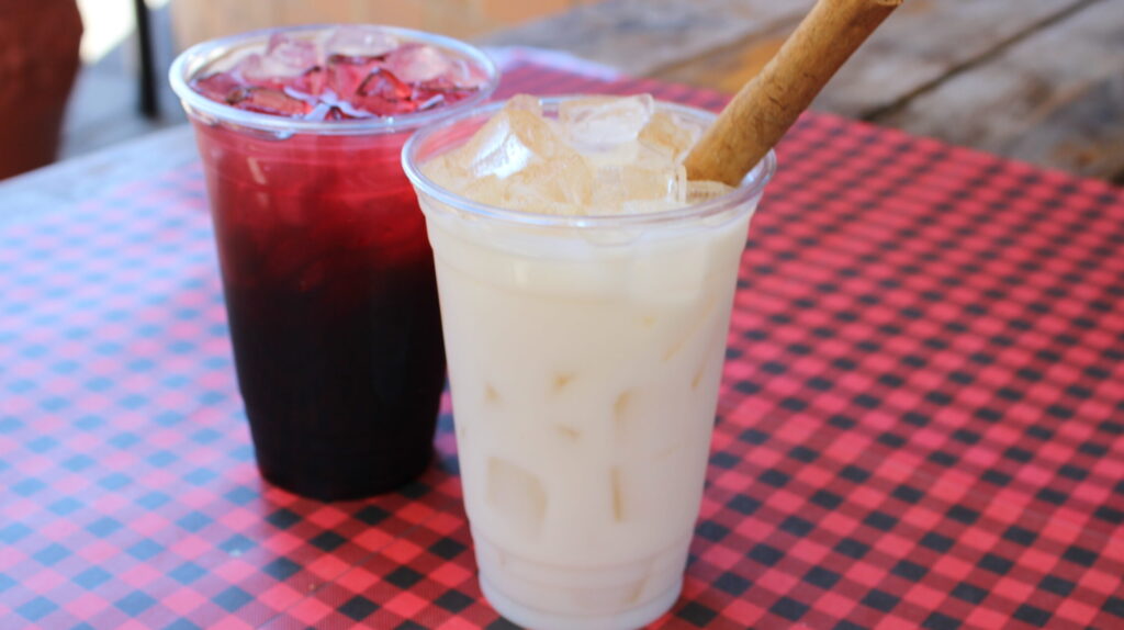 Mexican aguas frescas in red and creamy-colored drinks served at Los Tacos Locos